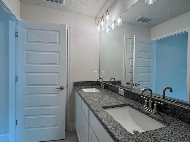 4038 Sagefield Dr, Harmony, FL 34773 - full bath featuring a textured ceiling, double vanity, and tile patterned flooring