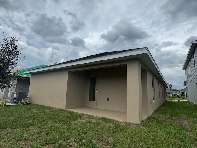 4038 Sagefield Dr, Harmony, FL 34773 - back of property with stucco siding, a yard, and a patio