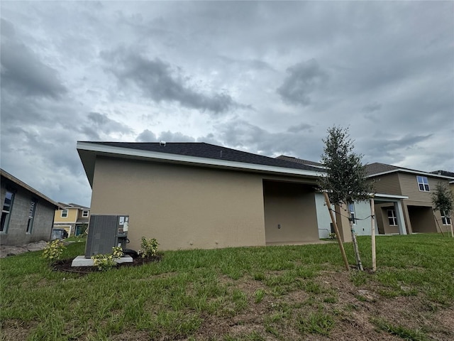 4038 Sagefield Dr, Harmony, FL 34773 - view of home's exterior with stucco siding and a lawn