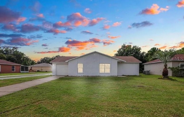 532 Koala Dr, Kissimmee, FL 34759 - view of side of home featuring concrete driveway, a lawn, and an attached garage