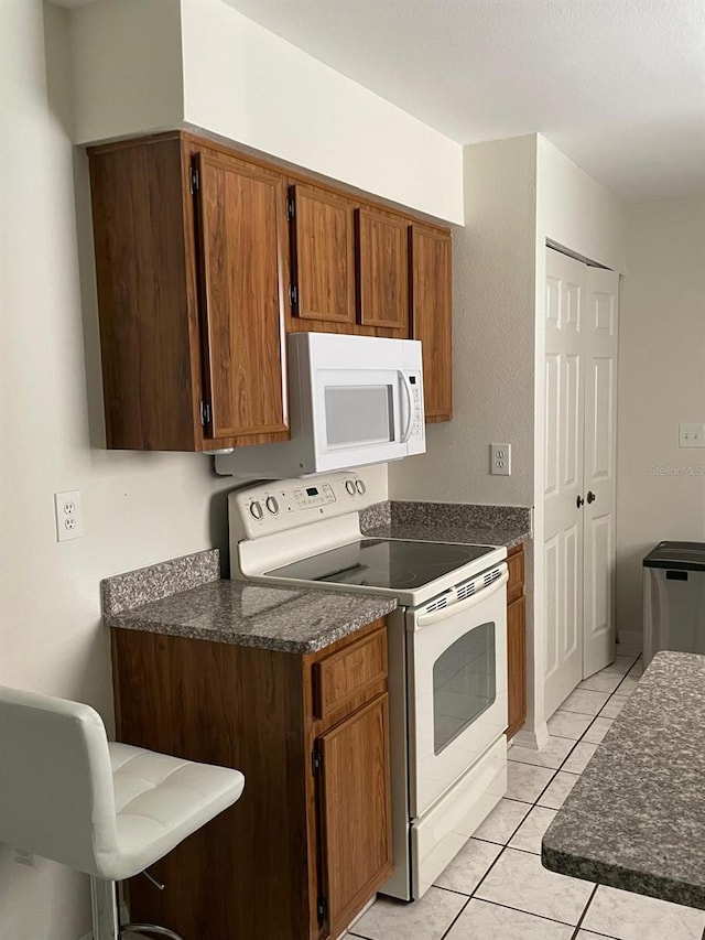 532 Koala Dr, Kissimmee, FL 34759 - kitchen featuring white appliances and brown cabinets