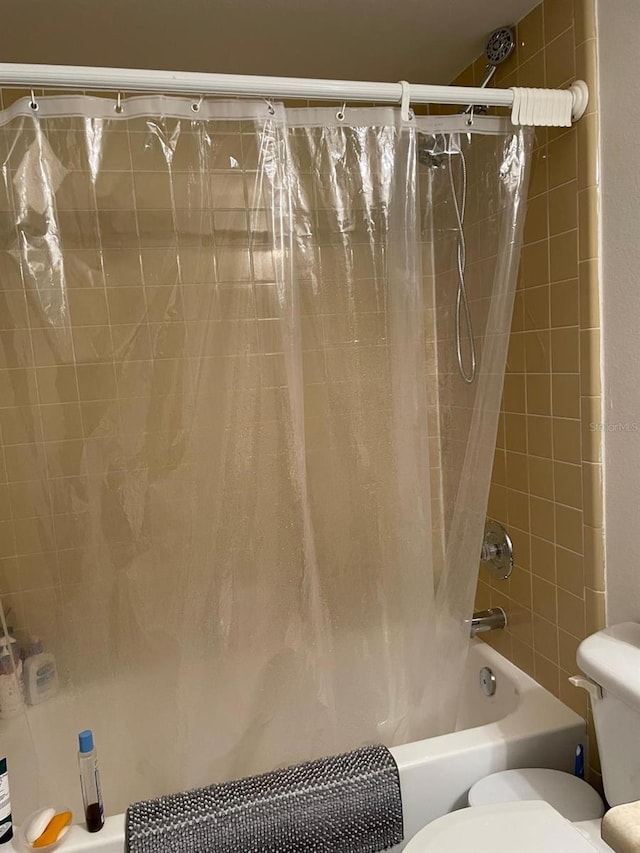 532 Koala Dr, Kissimmee, FL 34759 - bathroom with toilet and shower / bathtub combination with curtain