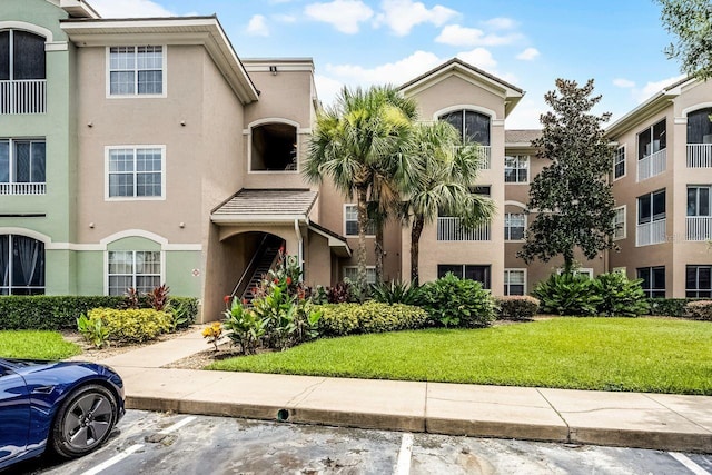 4881 Cypress Woods Dr Unit 3203, Orlando, FL 32811 - view of building exterior featuring uncovered parking