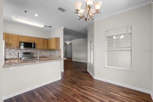 4881 Cypress Woods Dr Unit 3203, Orlando, FL 32811 - kitchen featuring stainless steel appliances, crown molding, tasteful backsplash, dark wood-style floors, and light stone countertops