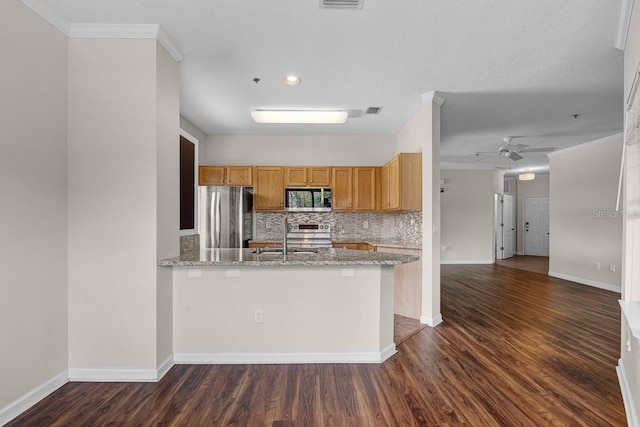 4881 Cypress Woods Dr Unit 3203, Orlando, FL 32811 - kitchen featuring appliances with stainless steel finishes, tasteful backsplash, dark wood-type flooring, ornamental molding, and ceiling fan