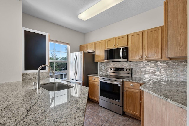 4881 Cypress Woods Dr Unit 3203, Orlando, FL 32811 - kitchen featuring appliances with stainless steel finishes, tasteful backsplash, light stone countertops, and dark tile patterned floors