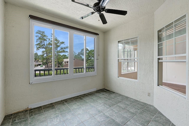 4881 Cypress Woods Dr Unit 3203, Orlando, FL 32811 - spare room featuring a textured wall, healthy amount of natural light, a textured ceiling, and a ceiling fan