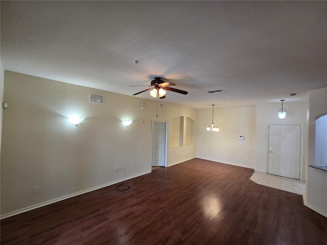 3001 Laurel Run Ln Unit 203, Kissimmee, FL 34741 - empty room featuring wood finished floors, a ceiling fan, a chandelier, and fire sprinkler in ceiling