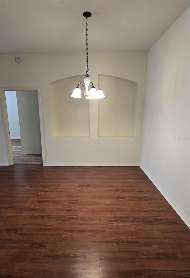 3001 Laurel Run Ln Unit 203, Kissimmee, FL 34741 - spare room featuring a chandelier, dark wood finished floors, and a smoke detector