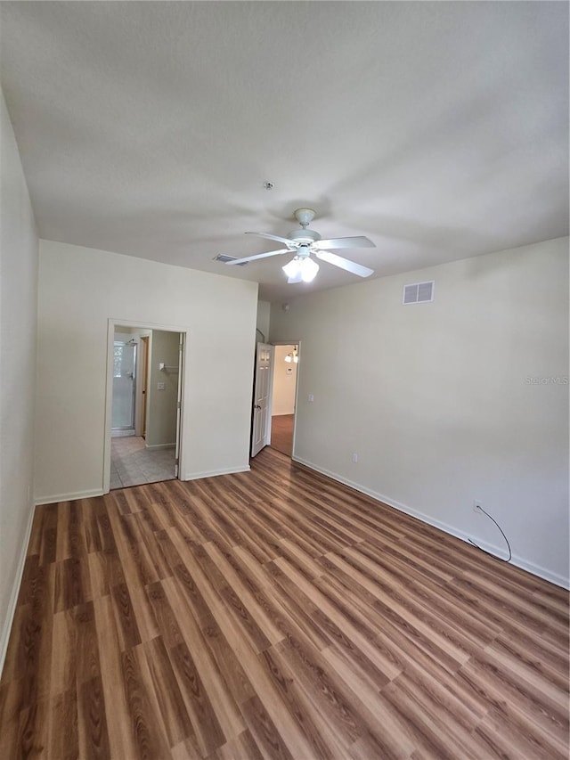 3001 Laurel Run Ln Unit 203, Kissimmee, FL 34741 - unfurnished bedroom featuring wood finished floors, connected bathroom, and ceiling fan