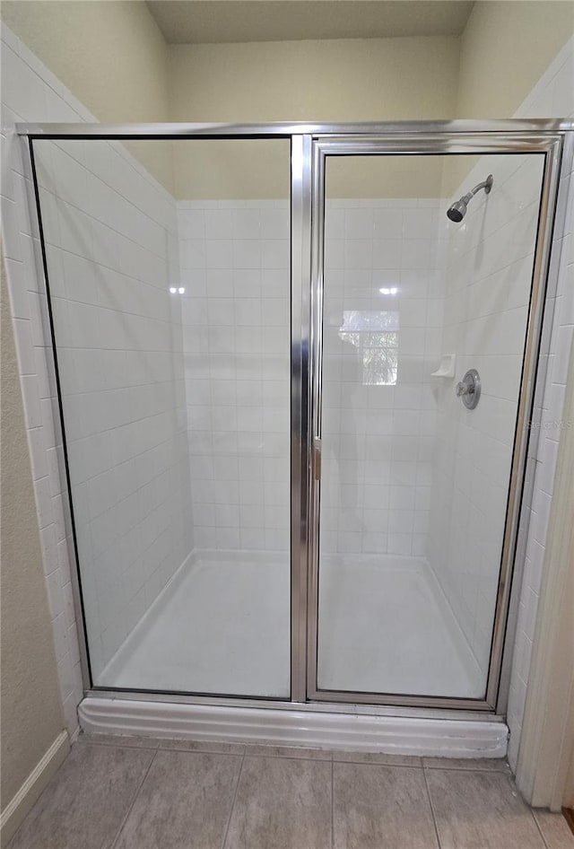 3001 Laurel Run Ln Unit 203, Kissimmee, FL 34741 - full bathroom featuring a stall shower and tile patterned floors