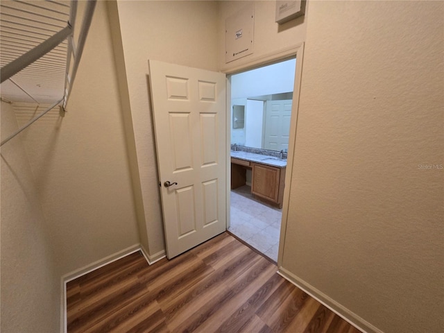 3001 Laurel Run Ln Unit 203, Kissimmee, FL 34741 - hallway featuring a sink and dark wood-style flooring