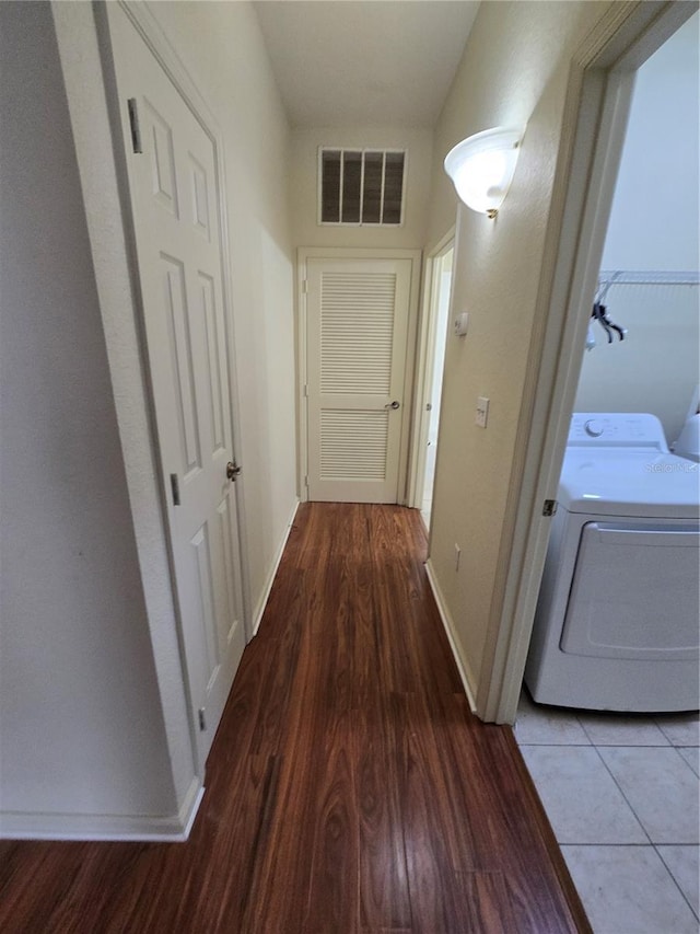 3001 Laurel Run Ln Unit 203, Kissimmee, FL 34741 - corridor featuring washer / dryer and wood finished floors