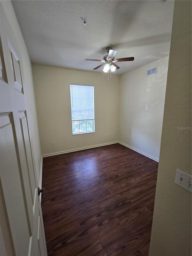 3001 Laurel Run Ln Unit 203, Kissimmee, FL 34741 - unfurnished room featuring ceiling fan, dark wood-style floors, a pendent fire sprinkler, and a textured ceiling