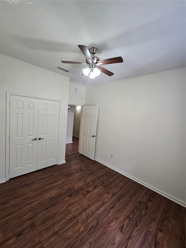 3001 Laurel Run Ln Unit 203, Kissimmee, FL 34741 - unfurnished bedroom featuring dark wood-style flooring, a closet, and ceiling fan