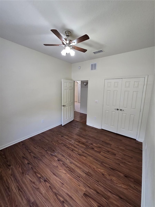 3001 Laurel Run Ln Unit 203, Kissimmee, FL 34741 - unfurnished bedroom with dark wood finished floors, ceiling fan, and a closet