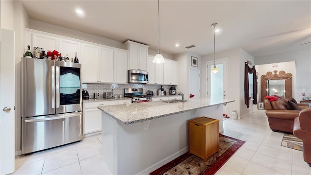16250 Firedragon Dr, Winter Garden, FL 34787 - kitchen featuring stainless steel appliances, decorative backsplash, light tile patterned floors, white cabinetry, and recessed lighting