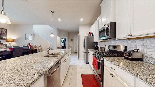 16250 Firedragon Dr, Winter Garden, FL 34787 - kitchen featuring stainless steel appliances, tasteful backsplash, light tile patterned floors, light stone countertops, and white cabinetry