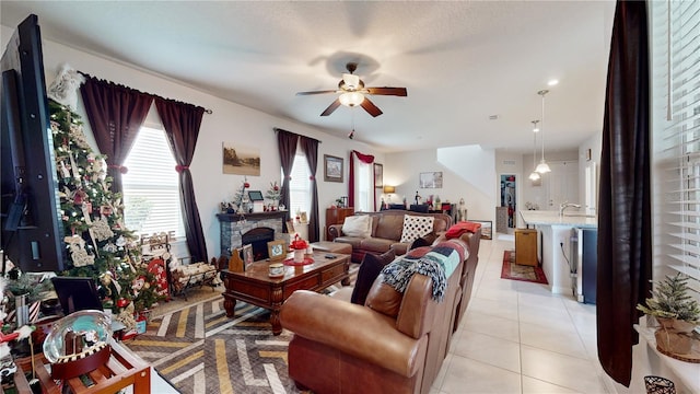 16250 Firedragon Dr, Winter Garden, FL 34787 - living area featuring a ceiling fan, light tile patterned flooring, and a stone fireplace