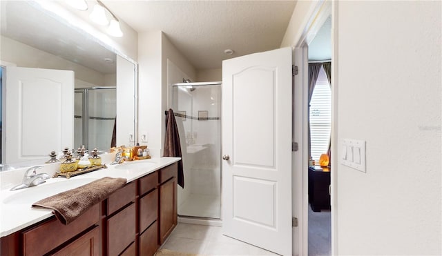16250 Firedragon Dr, Winter Garden, FL 34787 - full bathroom featuring a shower stall, tile patterned flooring, double vanity, and a textured ceiling