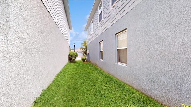 16250 Firedragon Dr, Winter Garden, FL 34787 - view of property exterior with stucco siding and a lawn