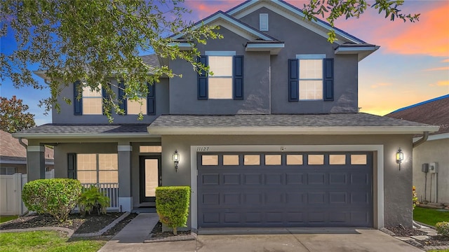 11127 Irish Moss Ave, Riverview, FL 33569 - traditional-style home with stucco siding, a garage, a porch, concrete driveway, and roof with shingles