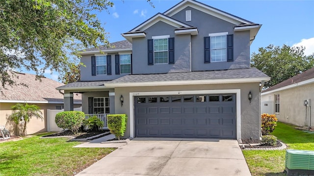 11127 Irish Moss Ave, Riverview, FL 33569 - traditional-style home featuring stucco siding, concrete driveway, an attached garage, and a front lawn