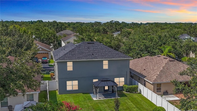 11127 Irish Moss Ave, Riverview, FL 33569 - rear view of house with a gazebo, stucco siding, a patio, a fenced backyard, and a forest view