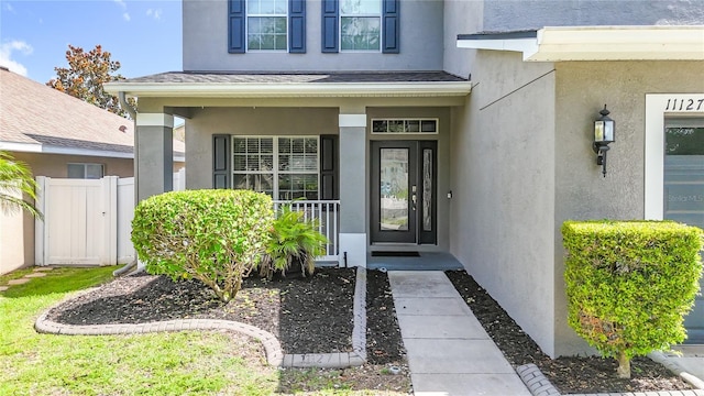 11127 Irish Moss Ave, Riverview, FL 33569 - view of exterior entry with stucco siding and a porch