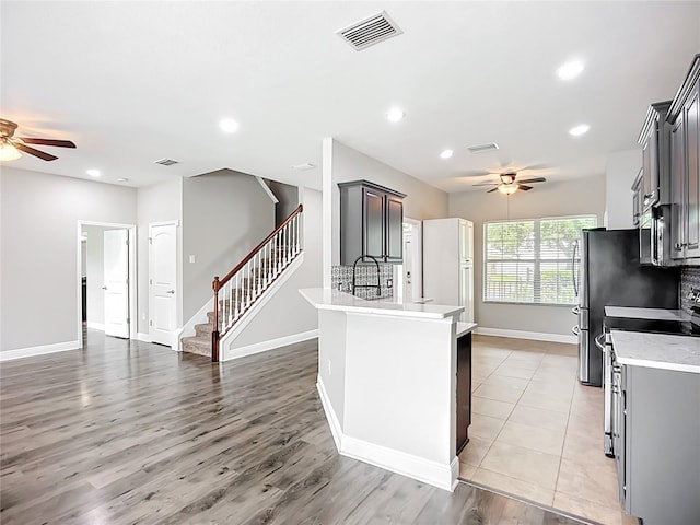 11127 Irish Moss Ave, Riverview, FL 33569 - kitchen with ceiling fan, light countertops, recessed lighting, light wood-style flooring, and open floor plan