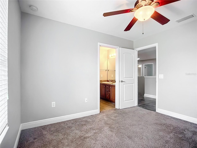 11127 Irish Moss Ave, Riverview, FL 33569 - unfurnished bedroom featuring light colored carpet, connected bathroom, and a ceiling fan