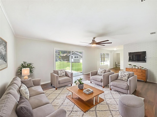 1215 Merlyn St, Lakeland, FL 33813 - living area featuring wood finished floors, ceiling fan, and crown molding