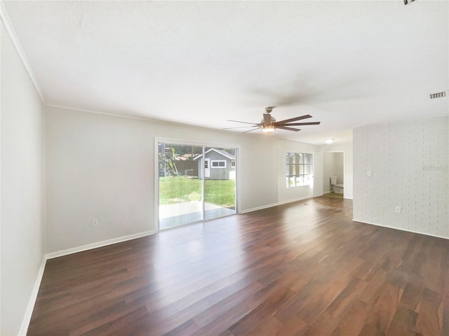 1215 Merlyn St, Lakeland, FL 33813 - unfurnished living room featuring plenty of natural light, dark wood finished floors, ceiling fan, and ornamental molding