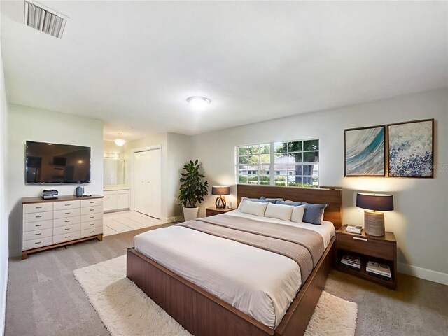 1215 Merlyn St, Lakeland, FL 33813 - bedroom with light carpet and ensuite bathroom
