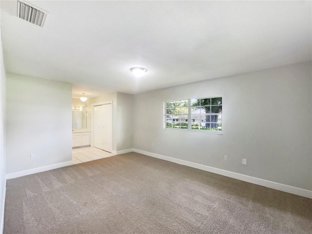 1215 Merlyn St, Lakeland, FL 33813 - carpeted empty room featuring baseboards