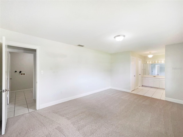 1215 Merlyn St, Lakeland, FL 33813 - spare room featuring light carpet and light tile patterned flooring