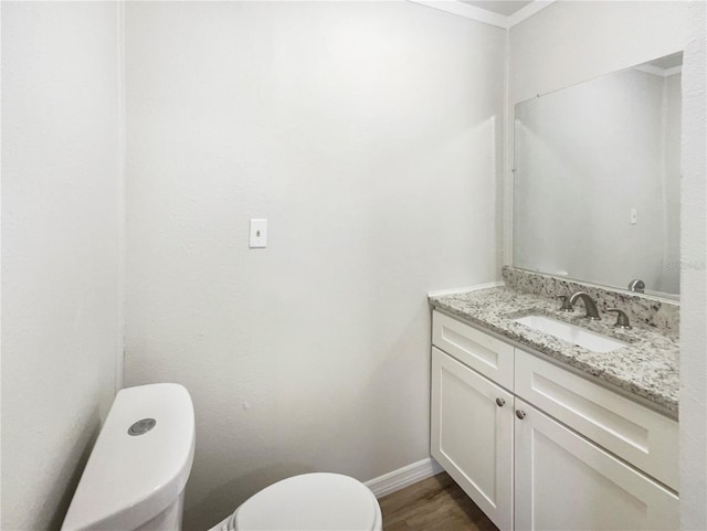 1215 Merlyn St, Lakeland, FL 33813 - half bath with vanity, wood finished floors, and ornamental molding