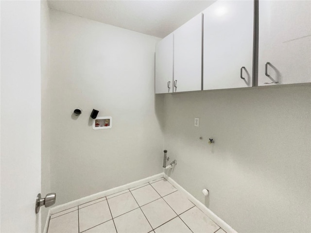 1215 Merlyn St, Lakeland, FL 33813 - laundry area featuring gas dryer hookup, cabinet space, light tile patterned floors, and hookup for a washing machine