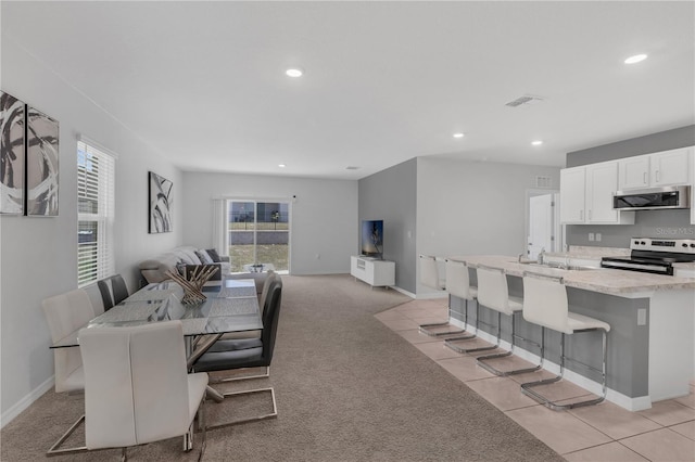 1296 Berry Ln, Davenport, FL 33837 - dining space featuring recessed lighting and light carpet