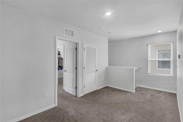 1296 Berry Ln, Davenport, FL 33837 - spare room featuring carpet, a textured ceiling, and recessed lighting