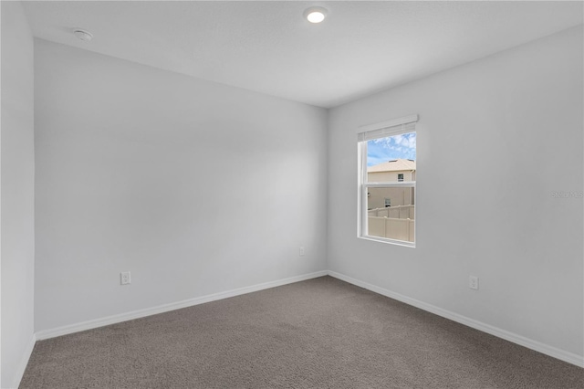 1296 Berry Ln, Davenport, FL 33837 - carpeted spare room with baseboards and a smoke detector