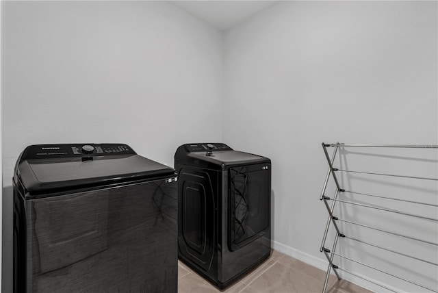 1296 Berry Ln, Davenport, FL 33837 - laundry room with separate washer and dryer and light tile patterned flooring