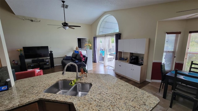 1632 Slash Pine Pl, Oviedo, FL 32765 - kitchen with ceiling fan, vaulted ceiling, white cabinetry, light stone counters, and open floor plan