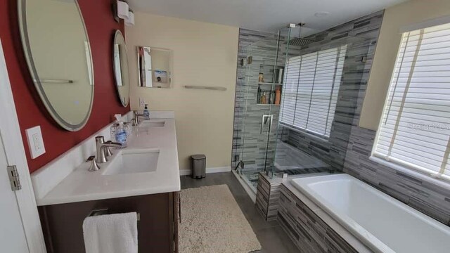 1632 Slash Pine Pl, Oviedo, FL 32765 - bathroom with healthy amount of natural light, a bath, double vanity, and a stall shower