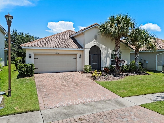 1330 Bucktail Ct, Kissimmee, FL 34746 - mediterranean / spanish house featuring stucco siding, an attached garage, and a tiled roof
