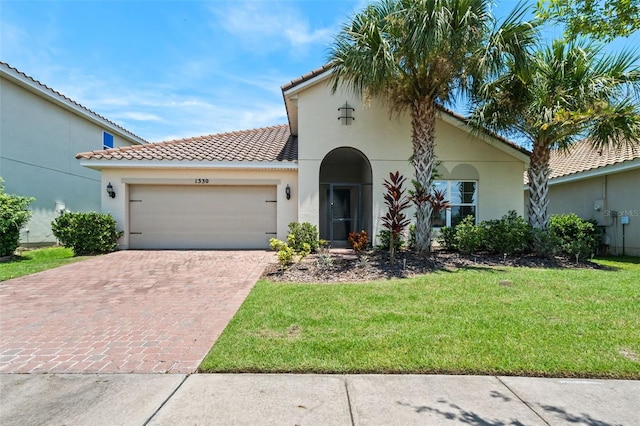 1330 Bucktail Ct, Kissimmee, FL 34746 - mediterranean / spanish-style house featuring decorative driveway, a garage, a front lawn, a tiled roof, and stucco siding
