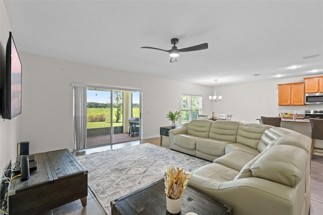 1330 Bucktail Ct, Kissimmee, FL 34746 - living area featuring a chandelier, ceiling fan, and light tile patterned floors