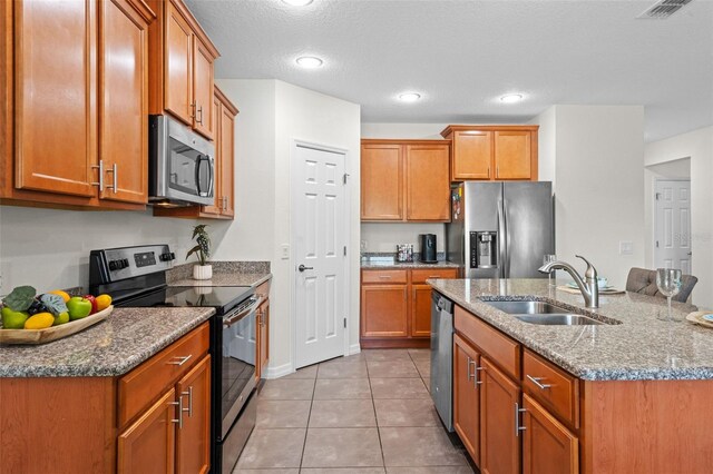 1330 Bucktail Ct, Kissimmee, FL 34746 - kitchen featuring stainless steel appliances, brown cabinets, stone countertops, and recessed lighting