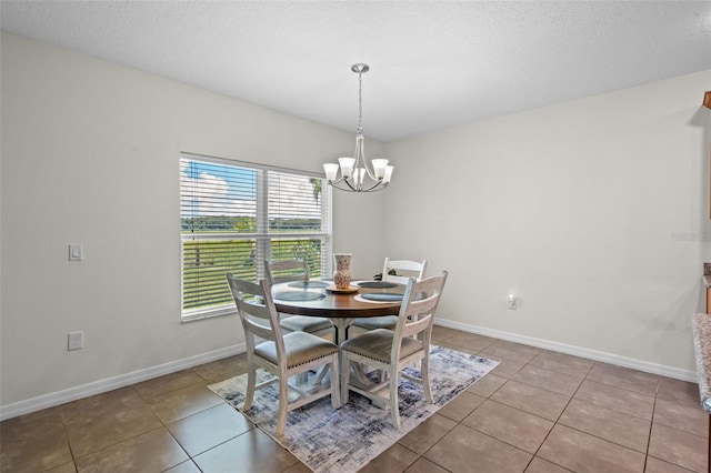 1330 Bucktail Ct, Kissimmee, FL 34746 - dining area with a chandelier, tile patterned flooring, and a textured ceiling