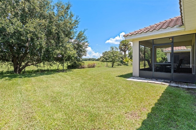 1330 Bucktail Ct, Kissimmee, FL 34746 - view of grassy yard with a sunroom